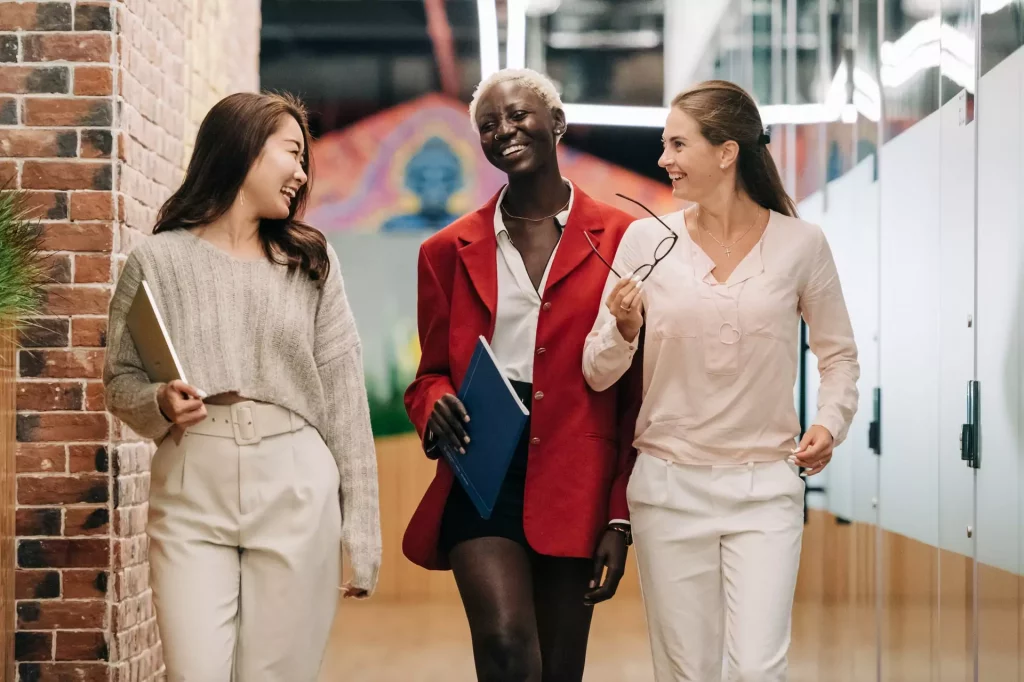 three happy girls talking