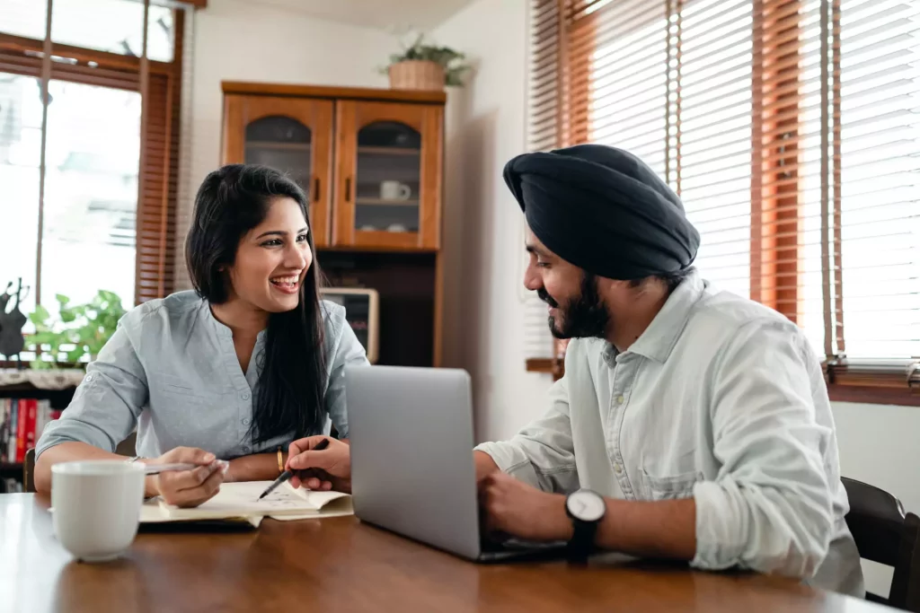 two people working with laptop