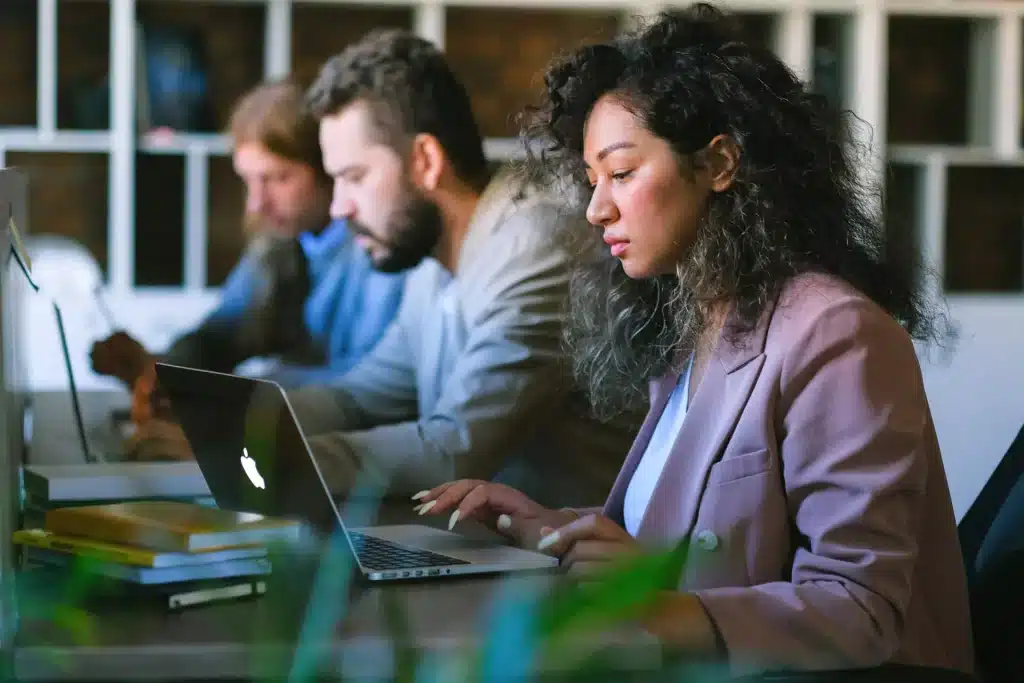 three people working with laptop