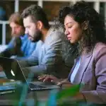 three people working with laptop