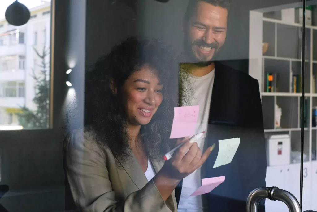 two office people working with post-it